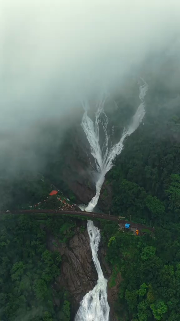 Vertical Aerial View of Dudhsagar Waterfall Surrounded by Lush Forest in Goa India