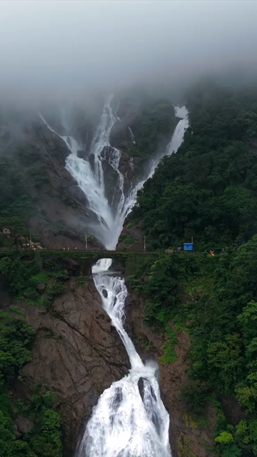 Vertical Aerial View of Dudhsagar Waterfall Surrounded by Lush Forest in Goa India