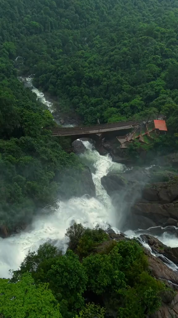 Vertical Aerial View of Dudhsagar Waterfall Surrounded by Lush Forest in Goa India
