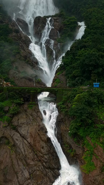 Vertical Aerial View of Dudhsagar Waterfall Surrounded by Lush Forest in Goa India