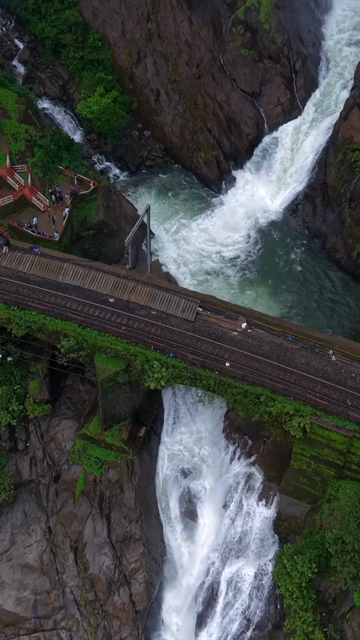 Vertical Aerial View of Dudhsagar Waterfall Surrounded by Lush Forest in Goa India
