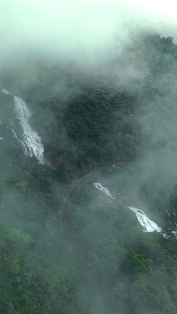 Vertical Aerial View of Dudhsagar Waterfall Surrounded by Lush Forest in Goa India