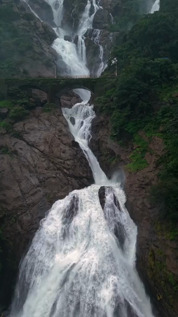 Vertical Aerial View of Dudhsagar Waterfall Surrounded by Lush Forest in Goa India