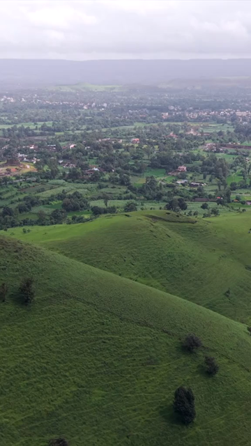 Vertical Aerial View of Lush Green Hills and Winding Roads in Ratnagiri Maharashtra India