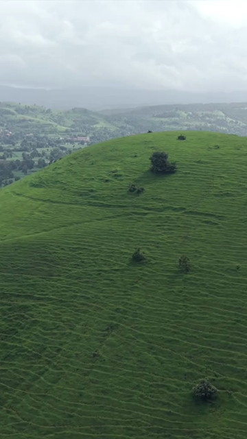 Vertical Aerial View of Lush Green Hills and Winding Roads in Ratnagiri Maharashtra India