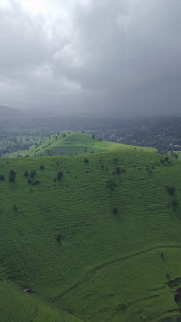 Vertical Aerial View of Lush Green Hills and Winding Roads in Ratnagiri Maharashtra India