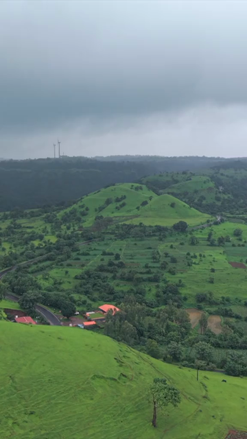 Vertical Aerial View of Lush Green Hills and Winding Roads in Ratnagiri Maharashtra India