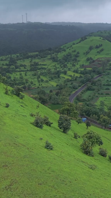 Vertical Aerial View of Lush Green Hills and Winding Roads in Ratnagiri Maharashtra India