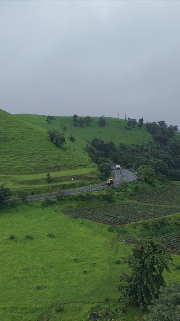 Vertical Aerial View of Lush Green Hills and Winding Roads in Ratnagiri Maharashtra India