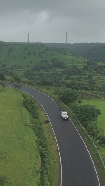 Vertical Aerial View of Lush Green Hills and Winding Roads in Ratnagiri Maharashtra India