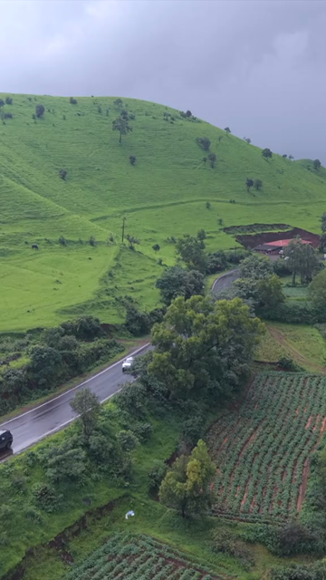 Vertical Aerial View of Lush Green Hills and Winding Roads in Ratnagiri Maharashtra India