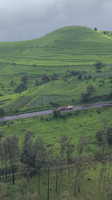 Vertical Aerial View of Lush Green Hills and Winding Roads in Ratnagiri Maharashtra India
