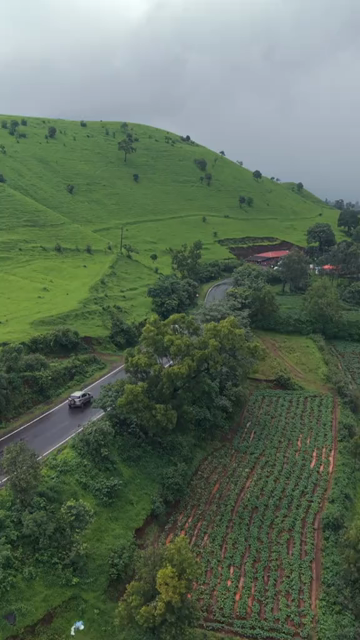 Vertical Aerial View of Lush Green Hills and Winding Roads in Ratnagiri Maharashtra India