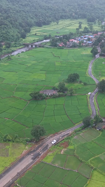 Vertical Aerial View of Lush Green Hills and Winding Roads in Ratnagiri Maharashtra India