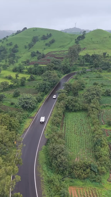 Vertical Aerial View of Lush Green Hills and Winding Roads in Ratnagiri Maharashtra India