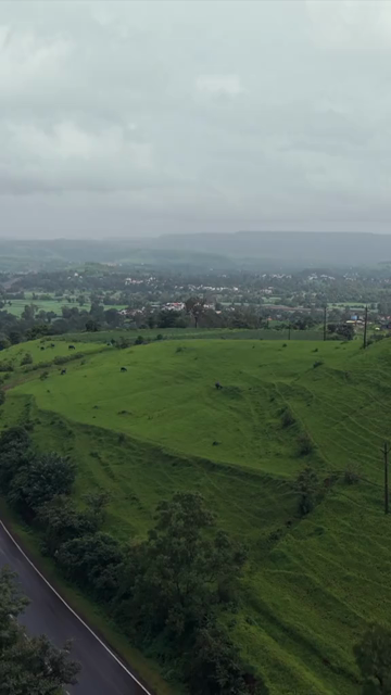 Vertical Aerial View of Lush Green Hills and Winding Roads in Ratnagiri Maharashtra India