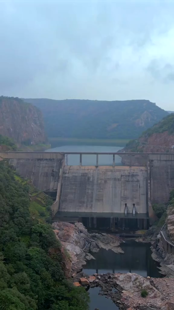 Vertical Aerial View of Jakham Dam and Misty Forested Hills Pratapgarh Rajasthan India