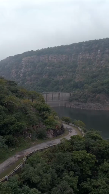 Vertical Aerial View of Jakham Dam and Misty Forested Hills Pratapgarh Rajasthan India