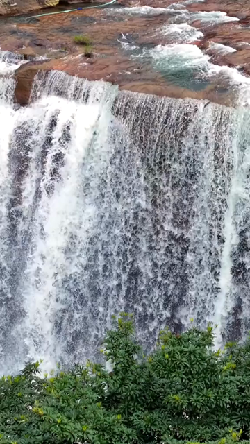 Vertical Aerial View of Krang Suri Falls and Lush Forest Landscape Meghalaya