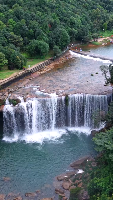 Vertical Aerial View of Krang Suri Falls and Lush Forest Landscape Meghalaya