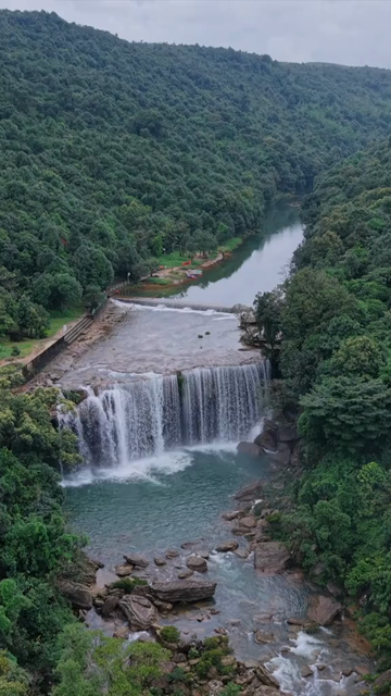 Vertical Aerial View of Krang Suri Falls and Lush Forest Landscape Meghalaya