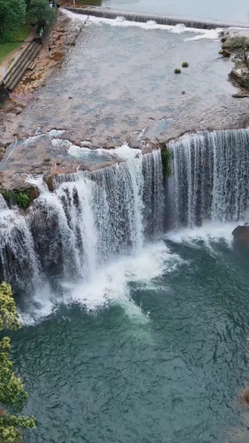 Vertical Aerial View of Krang Suri Falls and Lush Forest Landscape Meghalaya