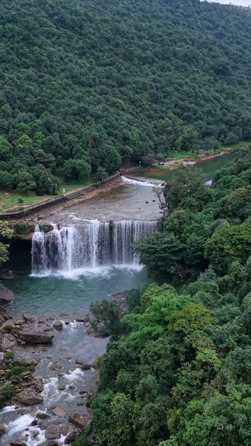 Vertical Aerial View of Krang Suri Falls and Lush Forest Landscape Meghalaya