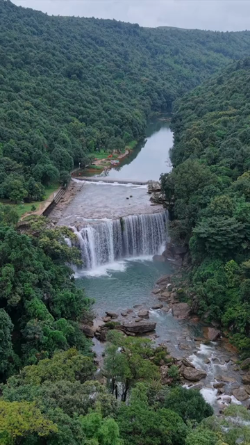 Vertical Aerial View of Krang Suri Falls and Lush Forest Landscape Meghalaya