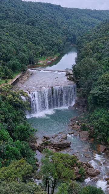 Vertical Aerial View of Krang Suri Falls and Lush Forest Landscape Meghalaya
