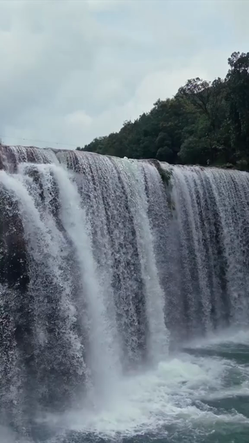 Vertical Aerial View of Krang Suri Falls and Lush Forest Landscape Meghalaya