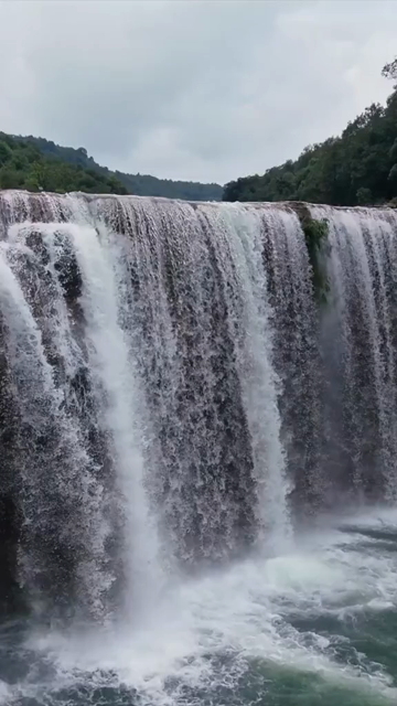 Vertical Aerial View of Krang Suri Falls and Lush Forest Landscape Meghalaya