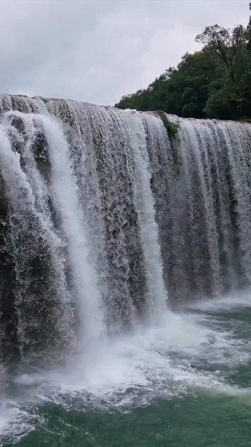 Vertical Aerial View of Krang Suri Falls and Lush Forest Landscape Meghalaya