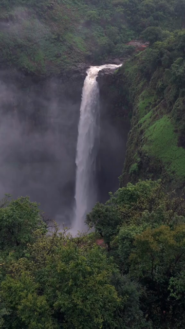 Vertical Aerial View of Kumbhe Waterfall and Misty Cliffs Maharashtra