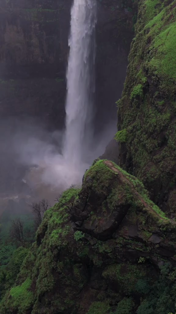 Vertical Aerial View of Kumbhe Waterfall and Misty Cliffs Maharashtra