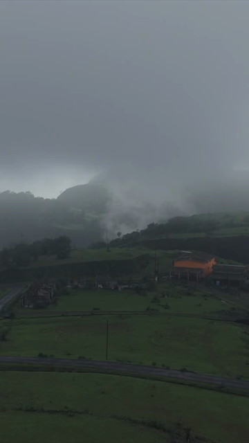 Vertical Aerial View of Kumbhe Waterfall and Misty Cliffs Maharashtra