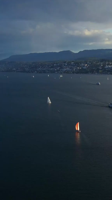 Vertical Aerial View of Lake Zurich and Sailboat in Switzerland