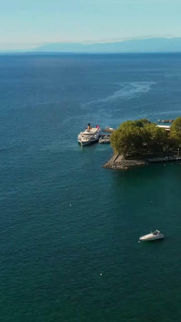 Vertical Aerial View of Lake Zurich and Sailboat in Switzerland