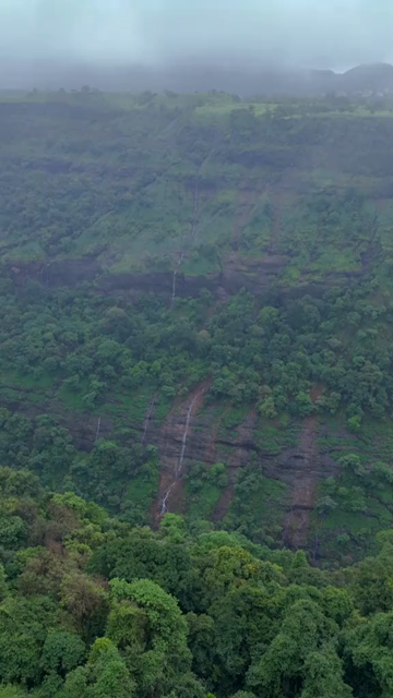 Vertical Aerial View of Lonavala Waterfall and Misty Green Hills During Monsoon Maharashtra