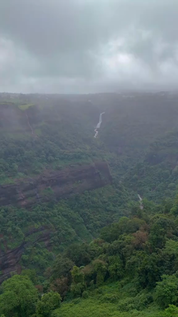 Vertical Aerial View of Lonavala Waterfall and Misty Green Hills During Monsoon Maharashtra