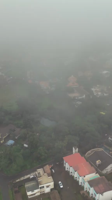 Vertical Aerial View of Lonavala Waterfall and Misty Green Hills During Monsoon Maharashtra
