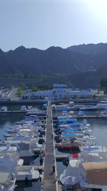 Vertical Aerial View of Marina Bandar Al Rowdha Muscat Oman with Yachts and Hajar Mountains