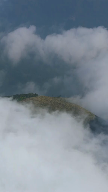 Vertical Aerial View of Mist Covered Hills at Kolukkumalai Munnar Kerala India