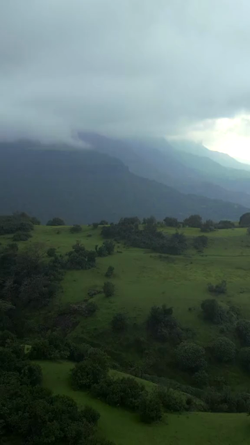 Vertical Aerial View of Misty Mountain Cliffs and Lush Green Landscapes in Maharashtra