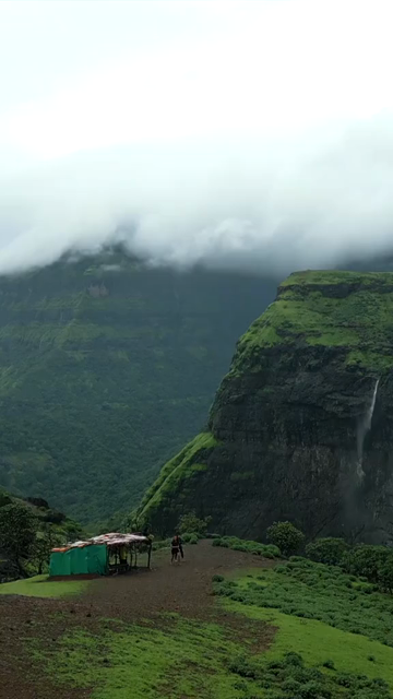 Vertical Aerial View of Misty Mountain Cliffs and Lush Green Landscapes in Maharashtra