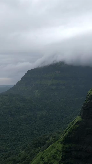 Vertical Aerial View of Misty Mountain Cliffs and Lush Green Landscapes in Maharashtra