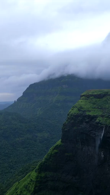 Vertical Aerial View of Misty Mountain Cliffs and Lush Green Landscapes in Maharashtra