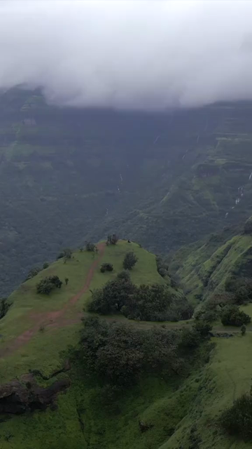 Vertical Aerial View of Misty Mountain Cliffs and Lush Green Landscapes in Maharashtra