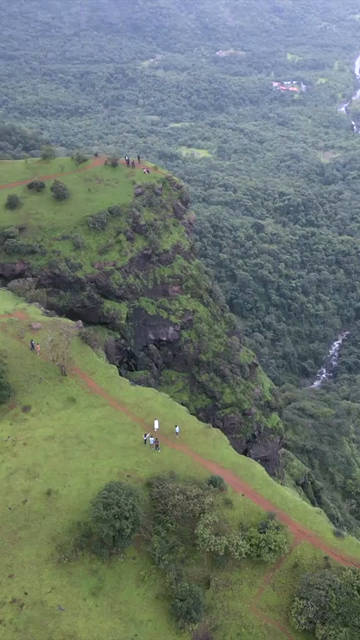 Vertical Aerial View of Misty Mountain Cliffs and Lush Green Landscapes in Maharashtra
