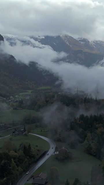 Vertical Aerial View of Misty Swiss Alps Landscape Switzerland