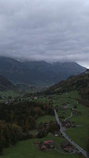 Vertical Aerial View of Misty Swiss Alps Landscape Switzerland